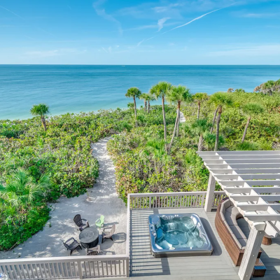 lush, tropical green vegetation surrounding Captiva vacation rental with ocean in the background