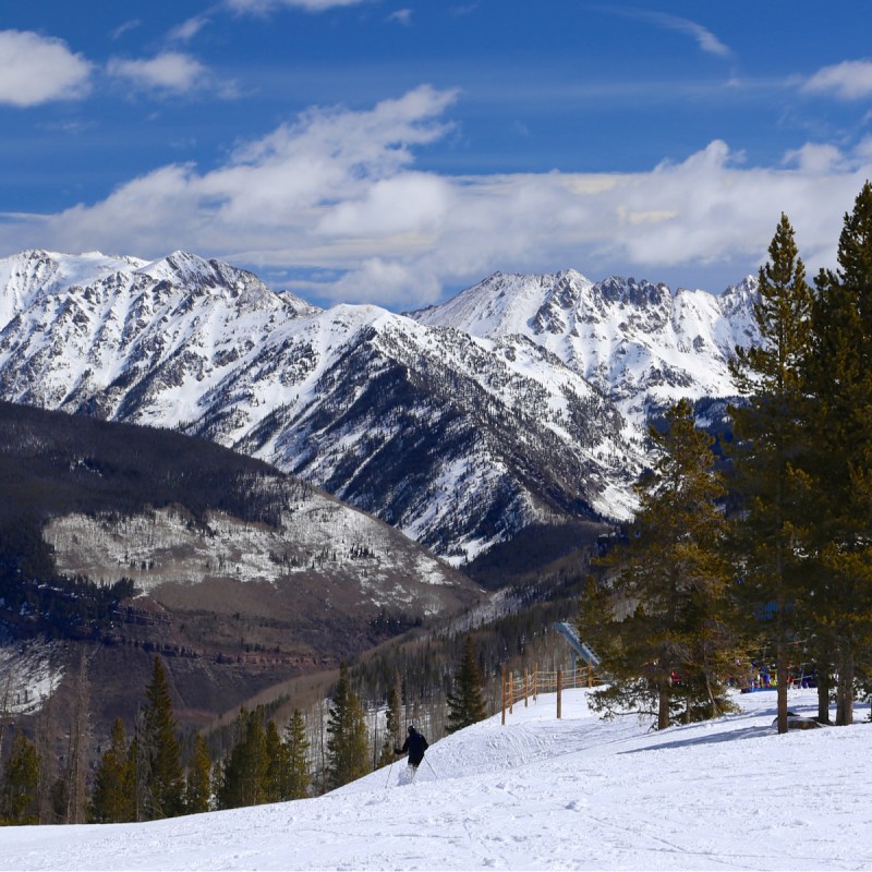 People skiing on run at Vail Colorado during the winter.
