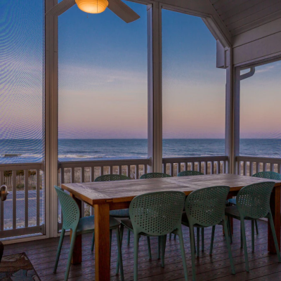 view of sunrise over the Atlantic from screened in porch of vacation rental in Rehoboth Beach