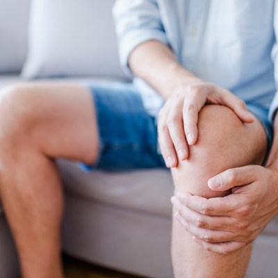 Person grasping knee.