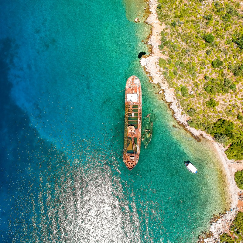 Aerial view over rusty shipwreck of an old cargo boat at Peristera island near Alonnisos, Sporades, Greece.