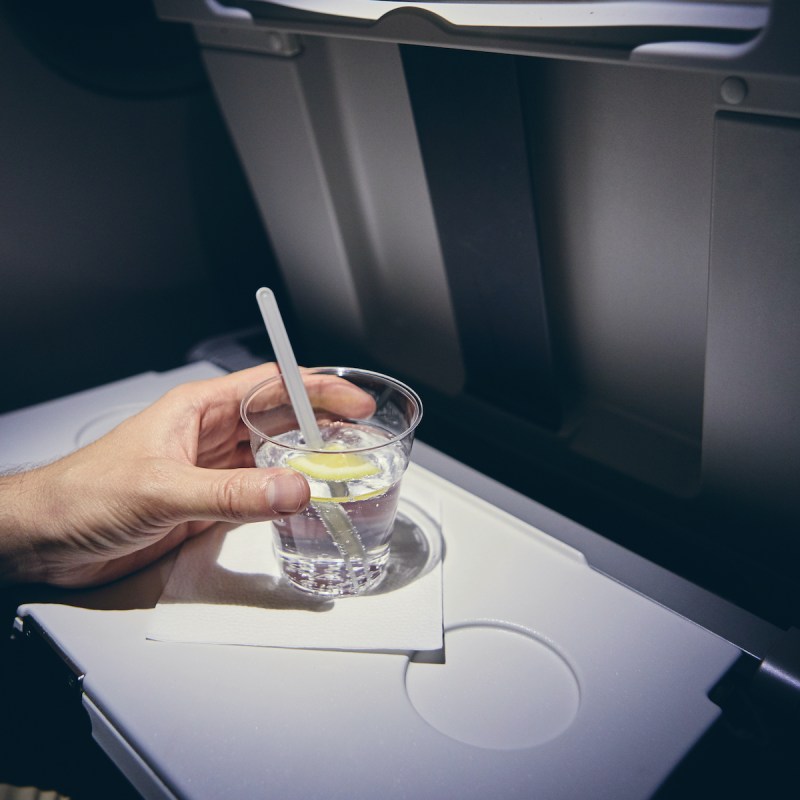 Airline passenger drinking cocktail