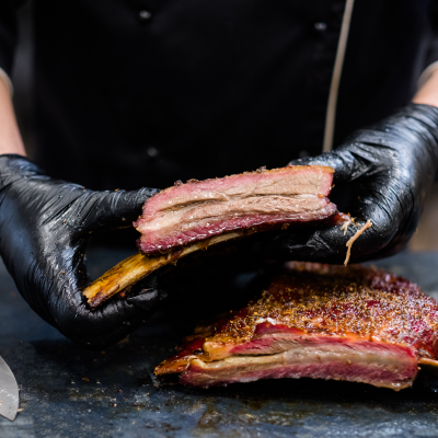 Chef slicing tender BBQ ribs