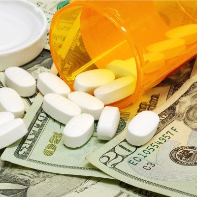 Prescription drugs on a money background