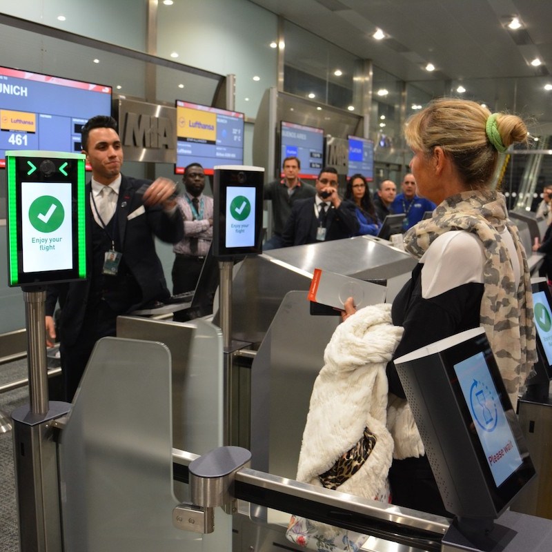 Woman stands in line for new biometric boarding in Miami