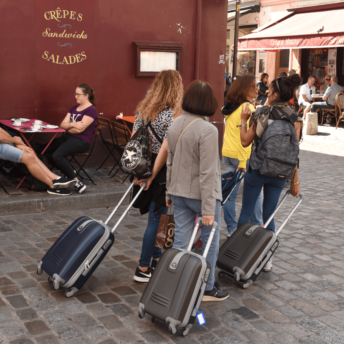 Tourists with luggage in Montmartre, Paris.
