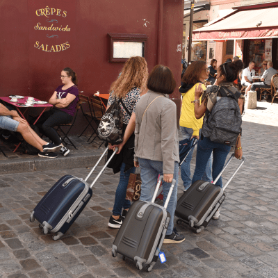 Tourists with luggage in Montmartre, Paris.
