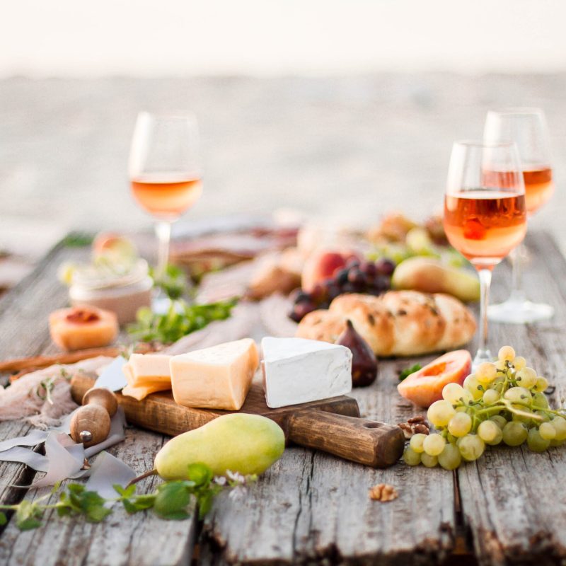 summer picnic with wine, cheese, and fruit