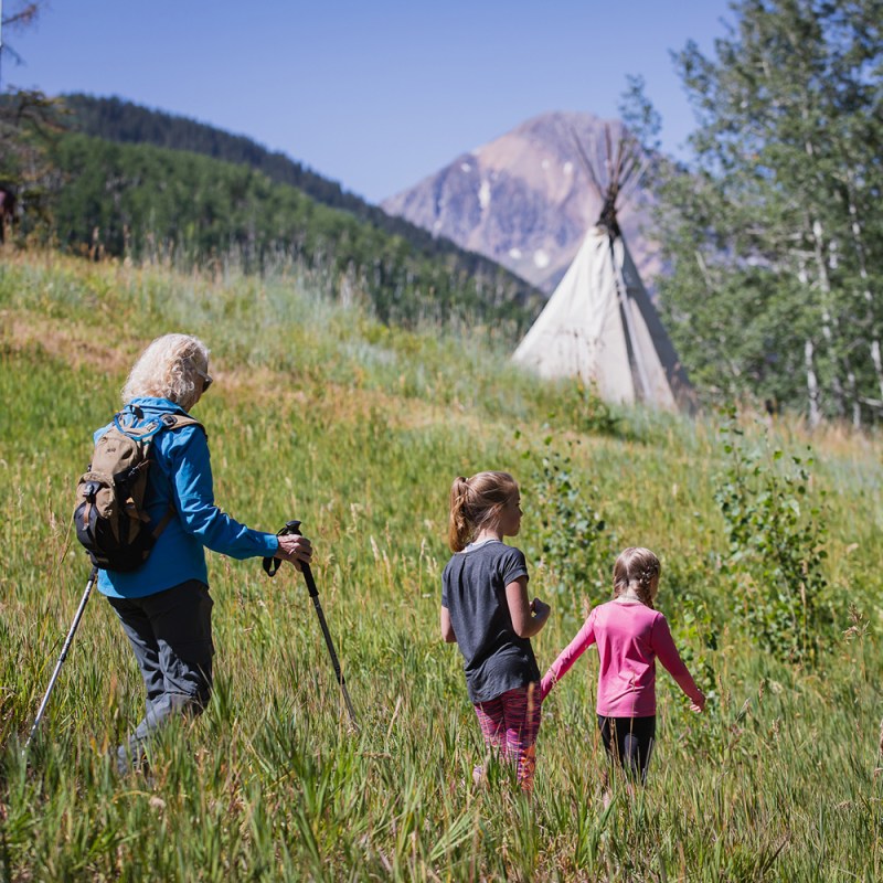 Woman and grandkids hiking