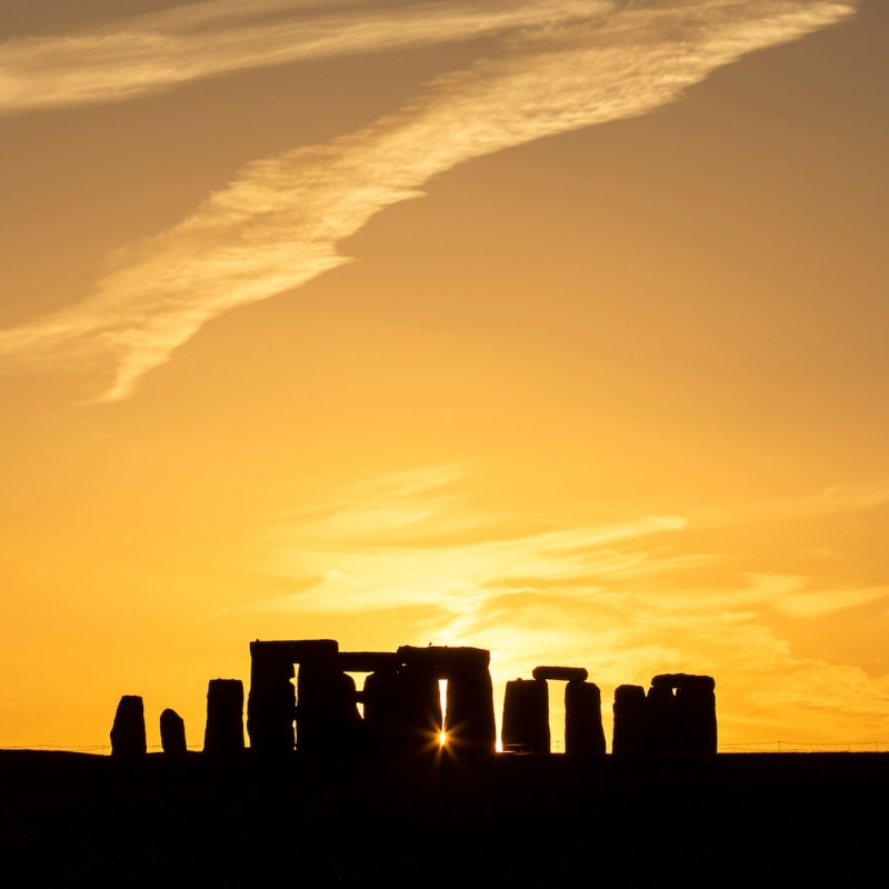 Stonehenge summer solstice sunset with sunburst