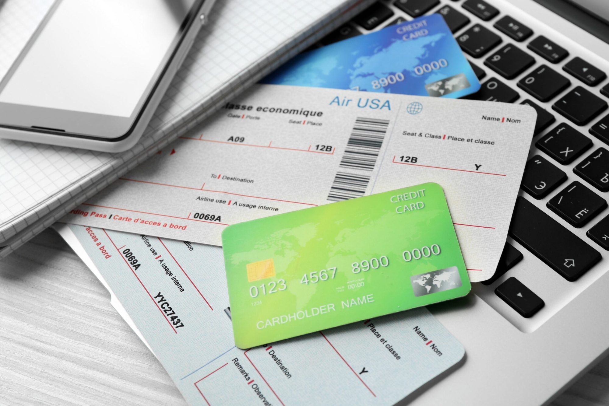 credit cards and airline boarding pass on laptop