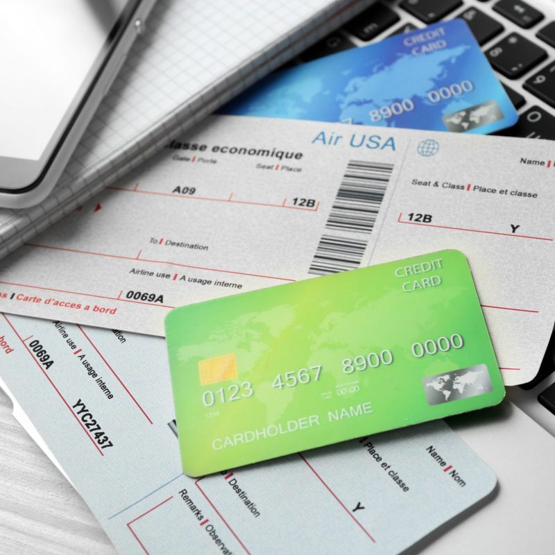 credit cards and airline boarding pass on laptop