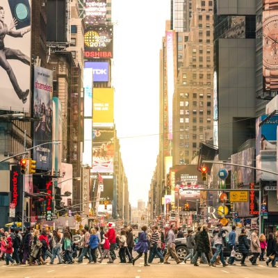 crowd of people walking across the street - New York City