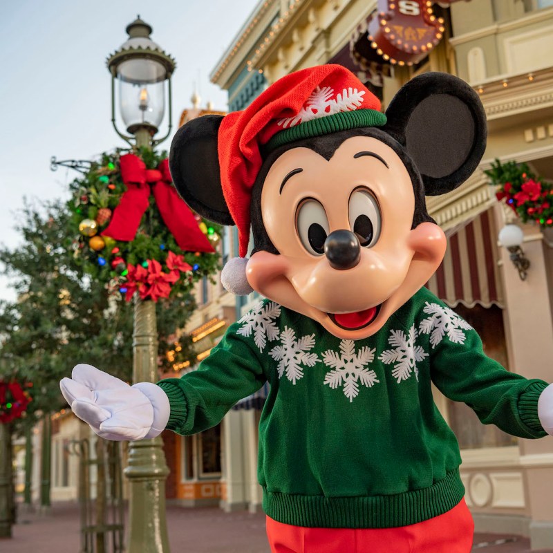 Micky Mouse wearing christmas sweater and hat on Main Street U.S.A. in the Magic Kingdom at Disney World