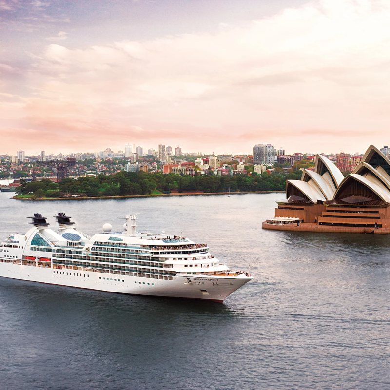 Seabourn cruise ship off the coast of Australia with Sydney Opera House in background