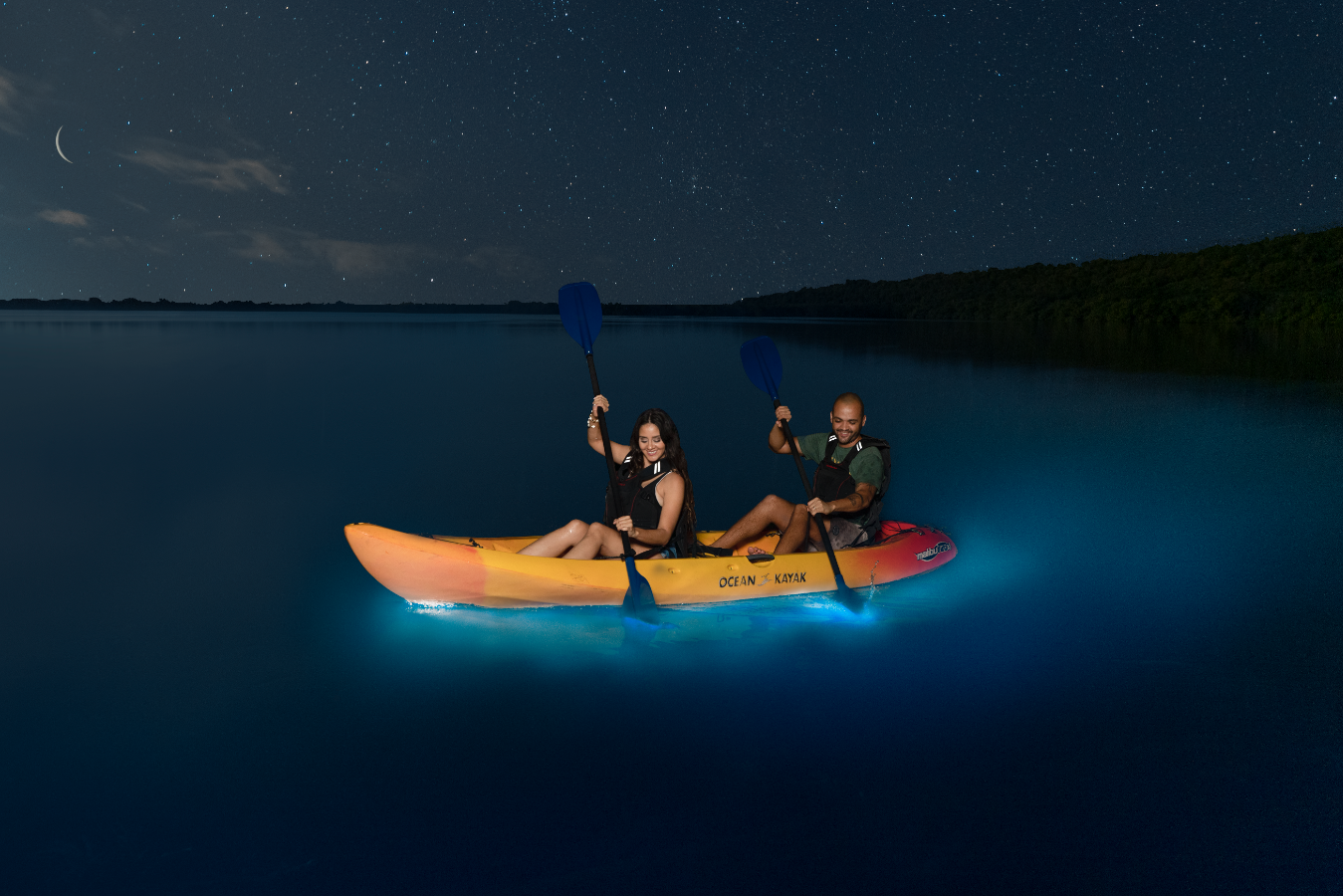 couple kayaking in a Bioluminescent Bay in Puerto Rico at night