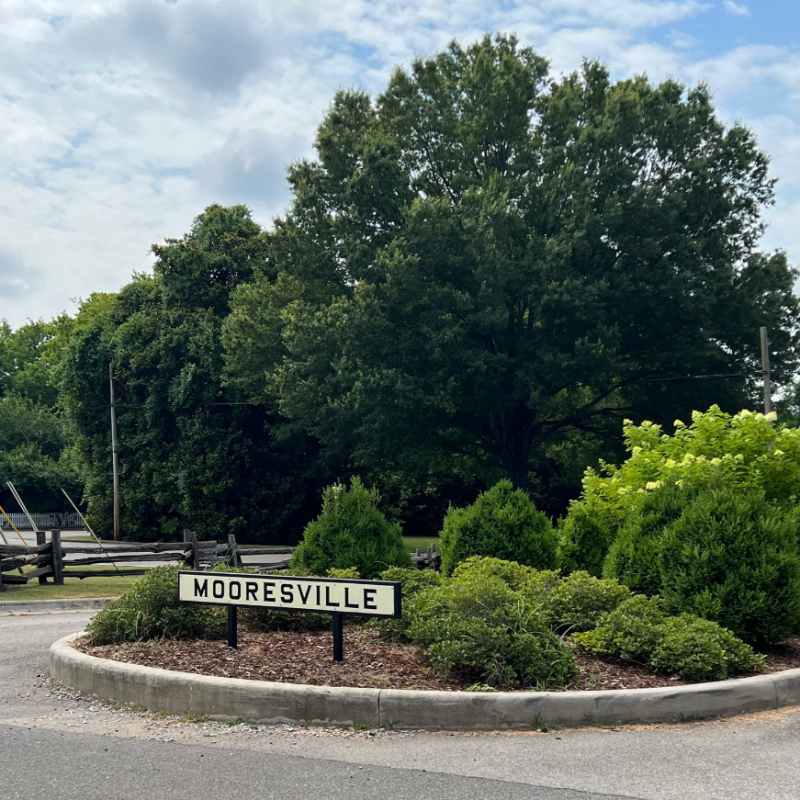 sign that says Mooresville surrounded by greenery