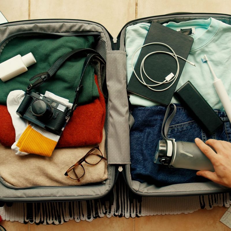 Packing carry-on suitcase with travel essentials