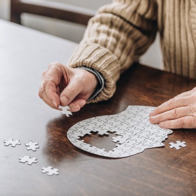 cropped view of senior man playing with puzzles