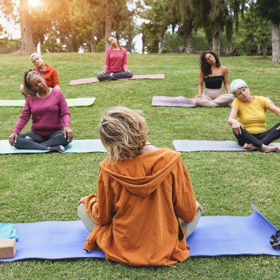 Multiracial people doing yoga sitting