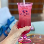 Strawberry-infused cocktail with a Disney Cruise Line logo on the glass.