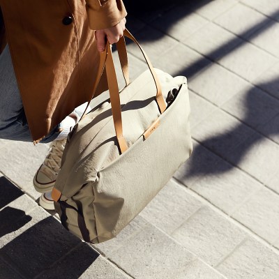 Person carrying Bellroy Weekender travel bag