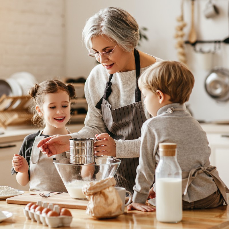 happy family grandmother and grandchildren cook in the kitchen