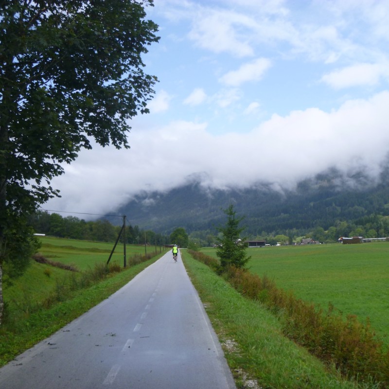 Bicyclist on a road near the Julian Alps, Slovenia.