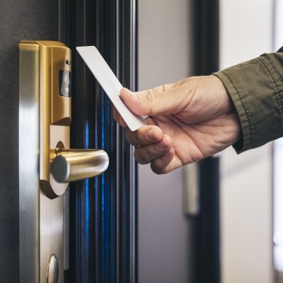 Entering hotel room with key card.