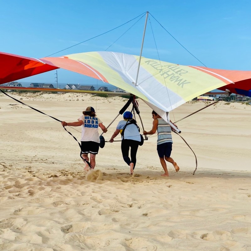 Woman hang gliding in Outer Banks, North Carolina.