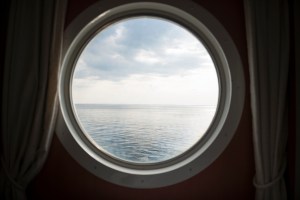 View of the sea from a round ship window