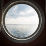 View of the sea from a round ship window