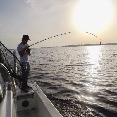 Tanner Philips gets his first fish hooked as the sun rises on Lake Kissimmee in Polk County, Florida.