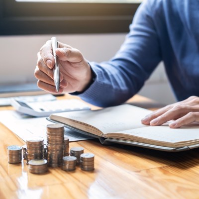 man and pile coins to planning growing saving strategy with pile coins for future plan fund of travel