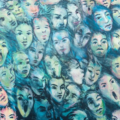 faces painted on Berlin Wall