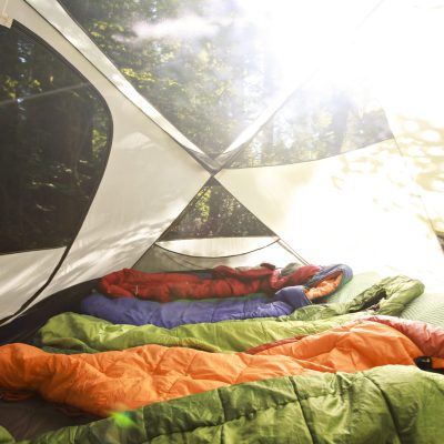 Sleeping bags lined up in a tent