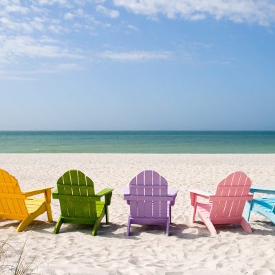colorful beach chairs in front of the ocean