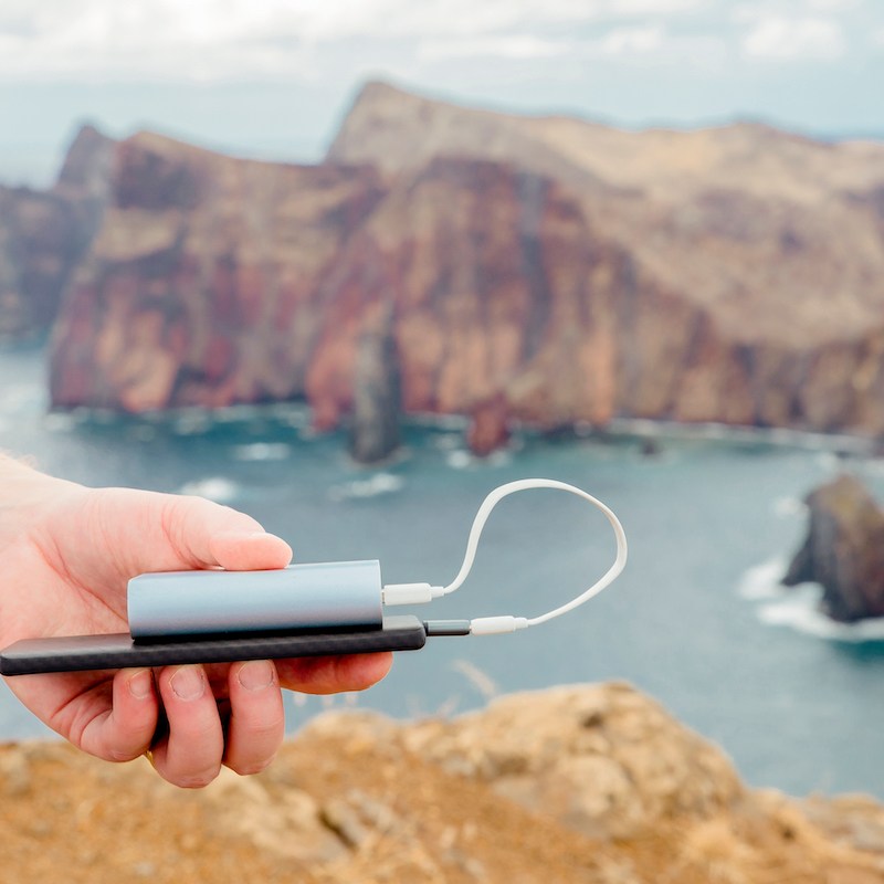 person holding portable power bank abroad
