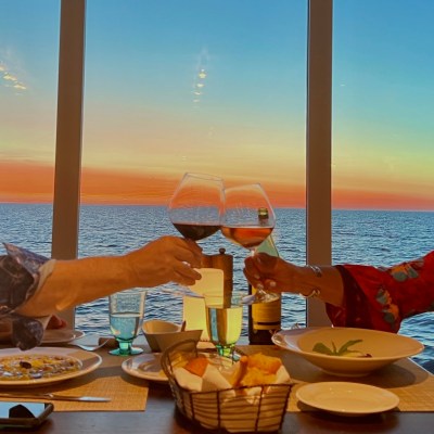 Wine glasses clinked together during sunset dinner at Manfredi's aboard the Viking Octantis.
