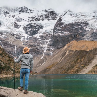Person hiking with a cane in the Andes Mountains.