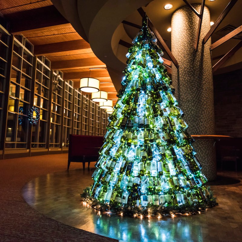 christmas tree made of wine bottles lit up from within