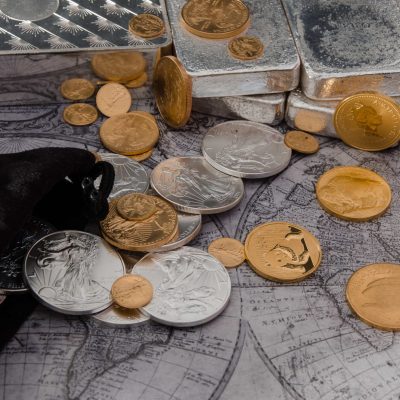 Gold and silver coins intermingled with silver bars