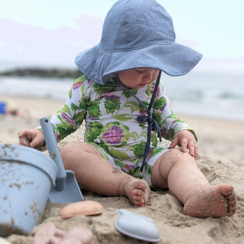 Toddler playing with ForeverElla silicone beach toys