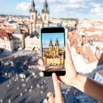 Person taking picture on cell phone with TravelSim card in Prague
