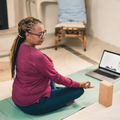 Woman meditating on a yoga mat.