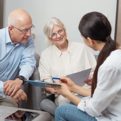 Elderly couple have a discussion with a woman