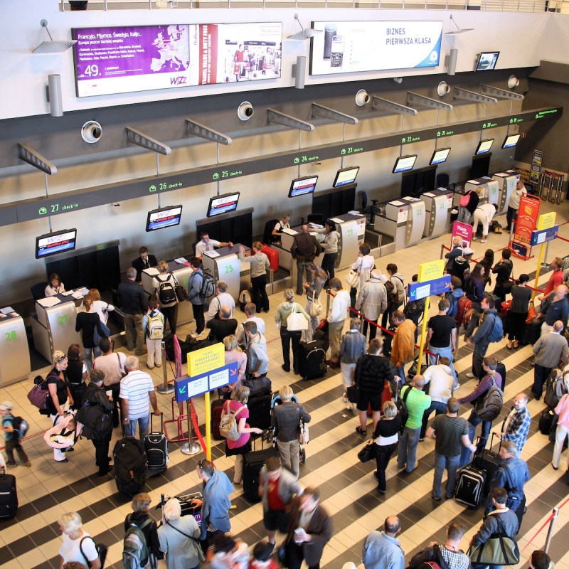 Travelers lined up at the airport checkin counter.