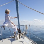 Woman sitting on a boat looking out over the ocean