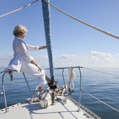 Woman sitting on a boat looking out over the ocean