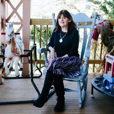 Bracha sitting on her front porch in Baltimore, Maryland